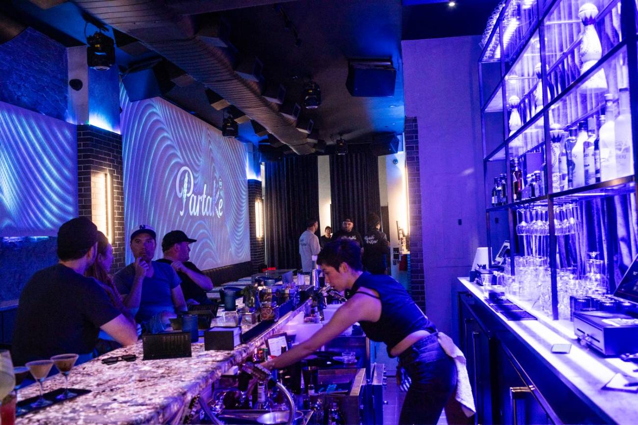 Bartenders working the marble bar at Partake NYC